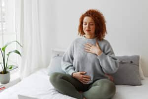A women practicing self-love by doing yoga